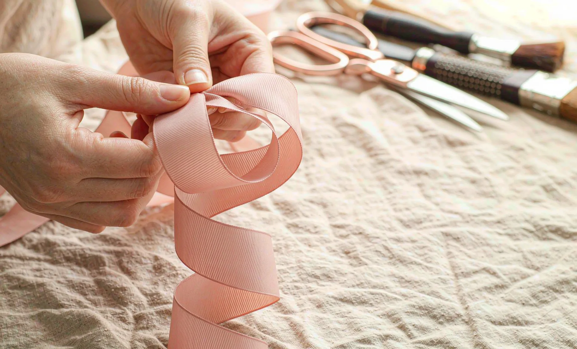 Tying a grosgrain ribbon bow by hand